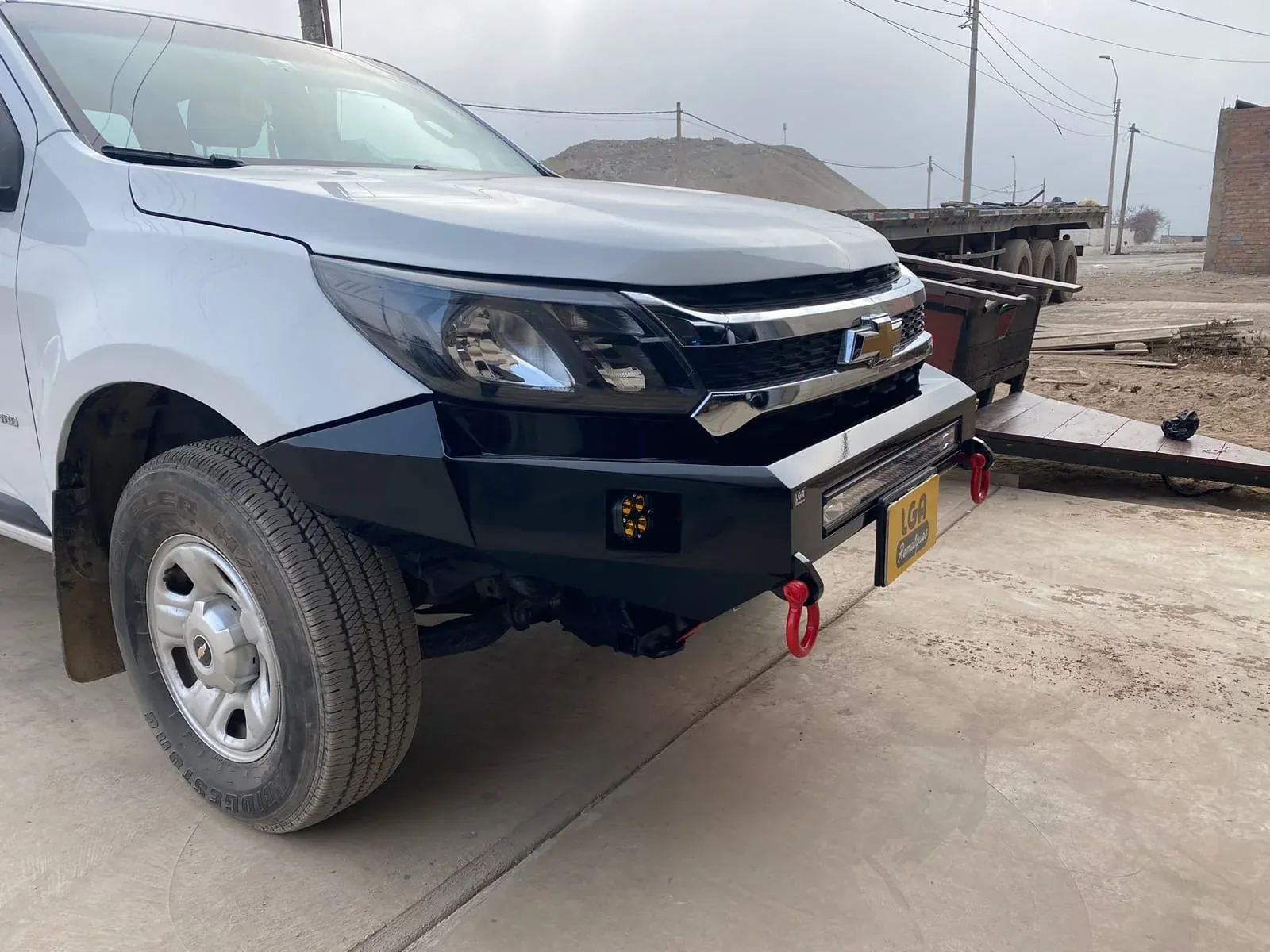 White Chevrolet pickup with a fabricated and installed front bumper